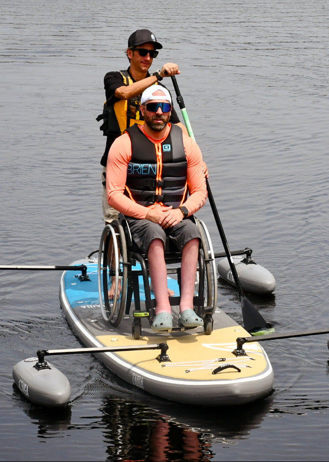 Two paddlers on the TAIGA Adaptive SUP on a lake
