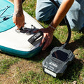 Person inflating a paddleboard with a Taiga pump