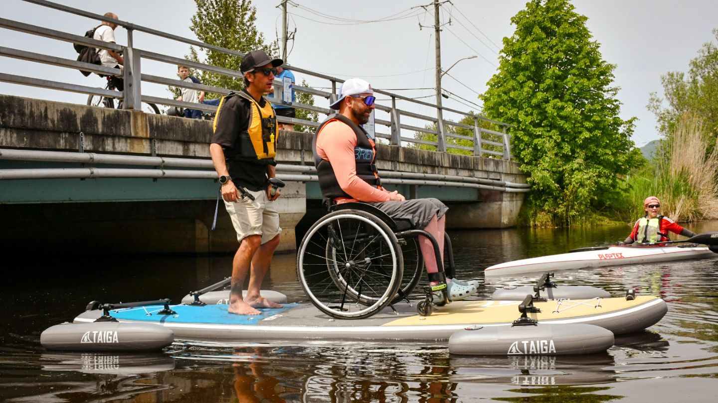 Two paddlers on the TAIGA Adaptive SUP