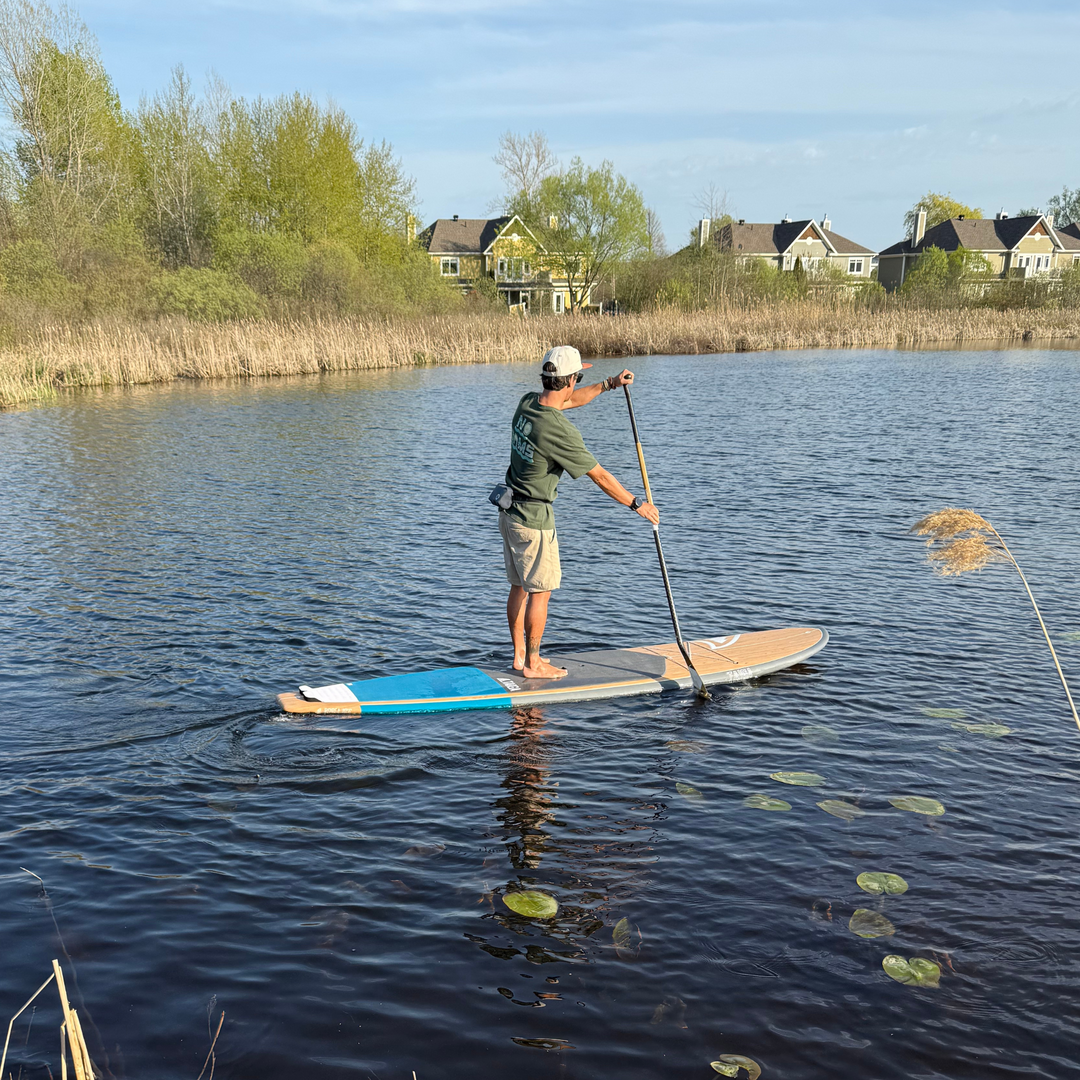 Side View of a Paddler On The Borea 10'6" in Color Sea Blue 