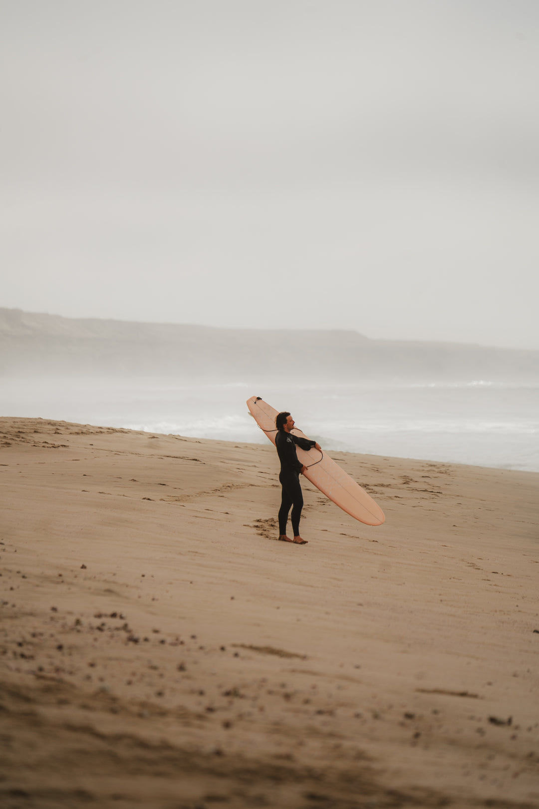 Surfer holding a pink board