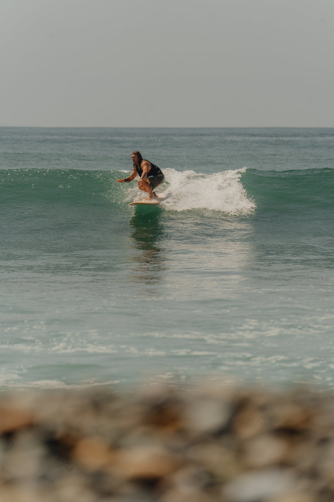 Guy surfing on the TAIGA Classic Longboard 8'4" in Dusty Pink