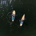 Two paddle boards on a body of water from an aerial perspective