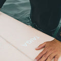 Guy Handling The Longboard Surf Board in The Rosé Color in The Ocean