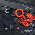 Nautical safety kit with dry bag, floating rope, whistle, carabiner clip, and LED light on a wooden surface.