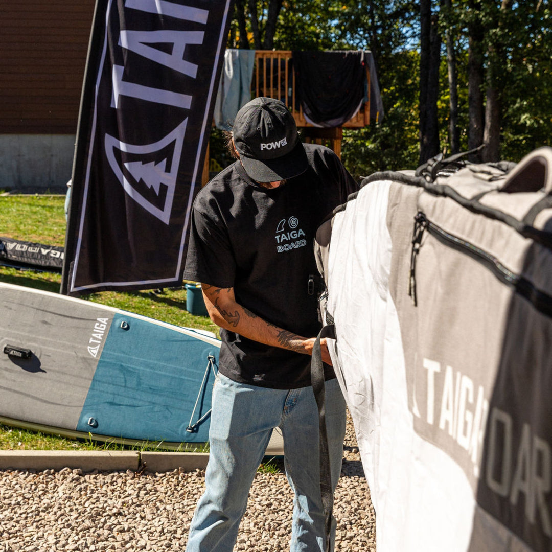 Person wearing a TAIGA BOARD t-shirt