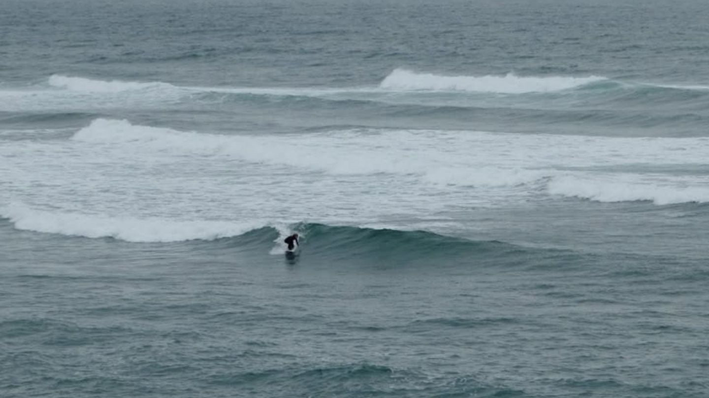 Person surfing on a wave in the ocean