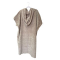 Beige poncho on a white hanger against a white background