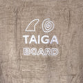 Text 'TAIGA BOARD' on a textured surface with a logo above it.