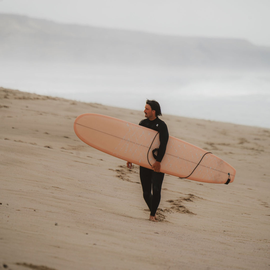 Surfer holding a pink board
