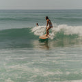 Surfer girl on a wave and wooden board